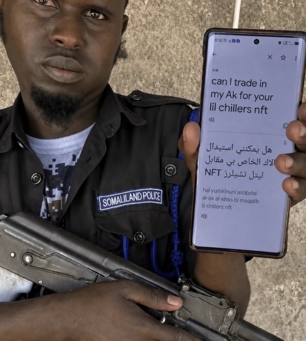 A Somaliland Police officer holds a phone displaying a Google Translate screen with the question "can I trade in my Ak for your lil chillers nft" in English, Arabic, and Somali, while also holding a firearm. The post "thoughts?" appears to joke about the absurdity of someone threatening armed officers over an NFT trade involving an "AK" (rifle) for "Lil Chillers" NFTs.