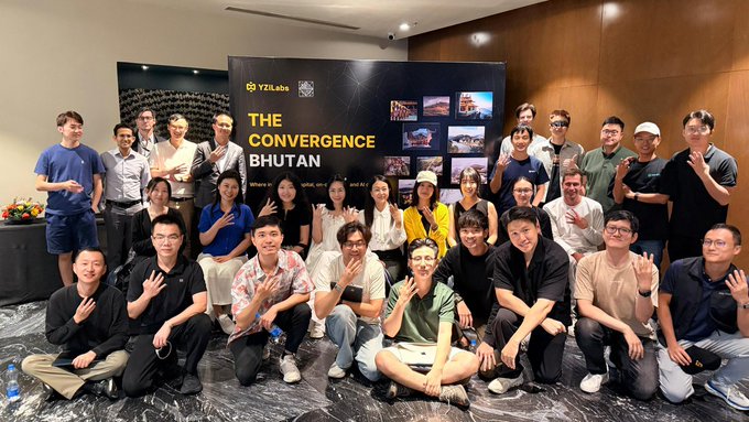 A large group photo of participants at "THE CONVERGE BHUTAN" event by YZiLabs, posing together in front of a backdrop displaying project images.