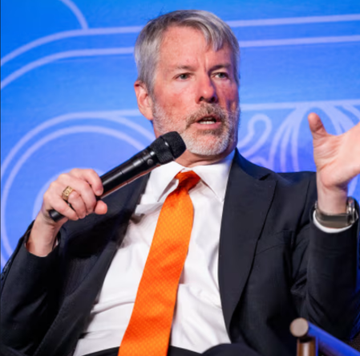 The image features a man wearing an orange tie and a suit jacket, standing behind a microphone while speaking at a podium. The background of the image is blue with white lines running across it, which could be part of a stage or presentation setup. The caption above the image reads "Michael Saylor, silencing the STRC skeptics: We will continue to raise billions and billions from the global credit market." This suggests that Michael Saylor is addressing an audience at a conference or event, possibly discussing his company's financial strategies or sharing insights about the cryptocurrency market.