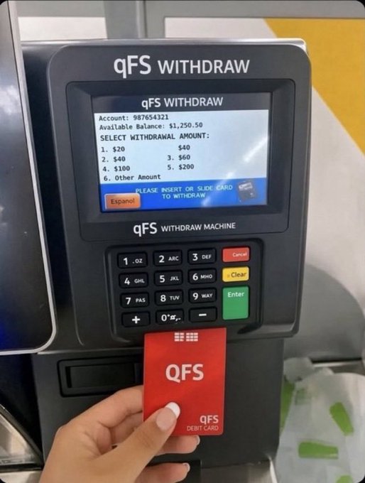 A hand holds a red QFS debit card in front of a QFS WITHDRAW MACHINE, which displays an account balance of $1,250.50.