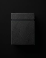 A dark, minimalist image shows a sleek black rectangular object (likely a product box or device) against a black background, visually reinforcing the post's enthusiastic message about preordering from TriX.market by conveying anticipation and a premium, mysterious aesthetic for the upcoming product.