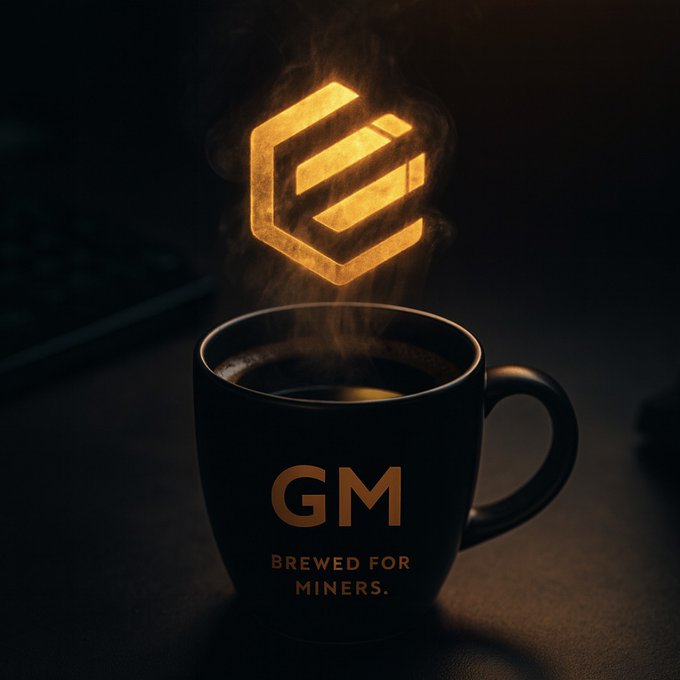 The image features a black coffee mug with the word "GEM" written on it. The mug has a steamy design above it, which appears to be made of a yellow material. The background of the image is dark, creating a contrast that makes the mug and its design stand out. There are no other objects or texts in the image, so the focus is solely on the coffee mug with the "GEM" logo.