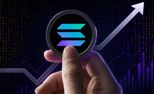 A hand holds up a glowing Solana (SOL) logo coin against a backdrop of binary code and rising financial charts with an upward-pointing arrow, symbolizing the blockchain's latest transaction upgrades and accelerating block times. The visual reinforces the post's announcement of Solana's V1 transaction launch and continued performance improvements.