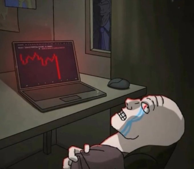 A cartoon character with red, glowing eyes cries blue tears while looking at a laptop displaying a sharply declining red line graph, suggesting a cryptocurrency or stock market crash.
