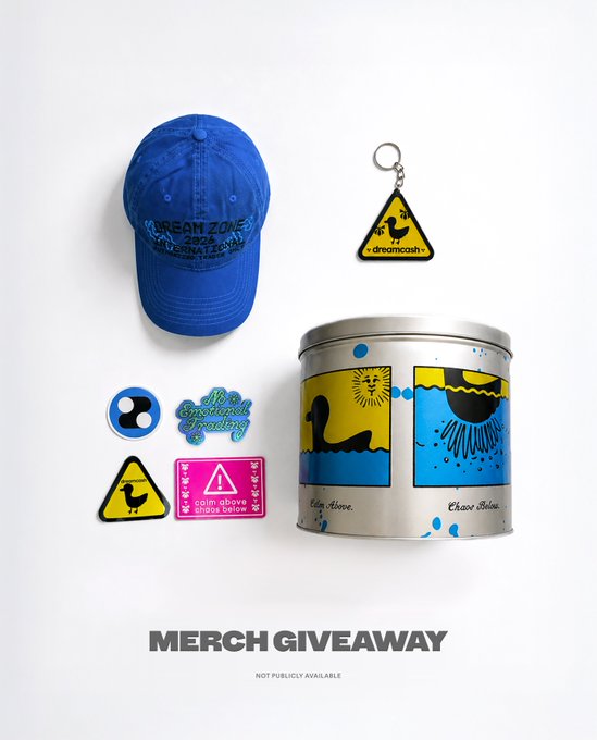 The image features a blue baseball cap, a silver tin canister with a picture of a bird on it, and several stickers or magnets scattered around the scene. The text "Merch Giveaway" is visible at the bottom right corner of the image.