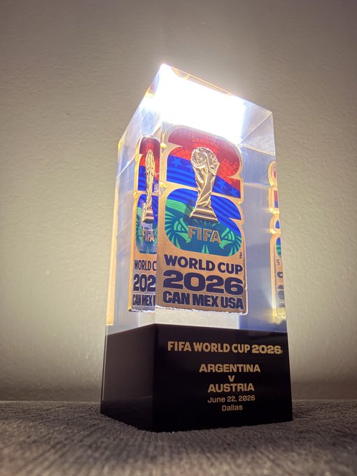 The image features a trophy that has been awarded for winning the FIFA World Cup. It is made of clear glass, showcasing the intricate details of the trophy's design. The trophy is placed on a black base, which contrasts with its transparent material. The text "Kept this one so did all of Argentina" can be seen in the image, indicating that the trophy was awarded to Argentina and not another country.
