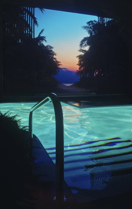 A view from inside an illuminated turquoise swimming pool at dusk, looking out through an open window framed by tropical plants toward a sunset over distant mountains.