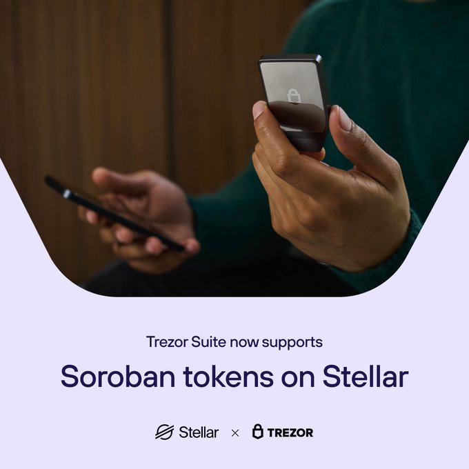 Hands holding a phone and a Trezor hardware wallet, with the caption 'Trezor Suite now supports Soroban tokens on Stellar' and Stellar x Trezor logos.