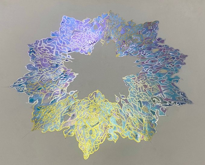 An abstract circular artwork composed of iridescent blue, purple, and yellow thread-like patterns arranged in a wreath shape on a neutral background.