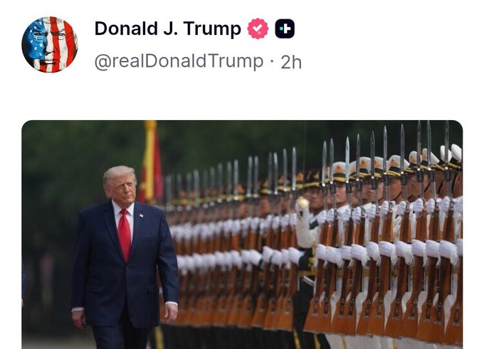 The image shows a man dressed in a suit walking through a group of people wearing military uniforms. The man appears to be President Donald Trump, who is known for his interest in space exploration. The photo captures him at an event where Bitcoin serves as a leading indicator for the US stock market, indicating that it might be a good idea to invest in the cryptocurrency. The post also mentions the World Cup and the US stock market's response to Musk'S SpaceX IPO on June 12th.