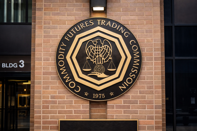 The image shows the official seal of the **Commodity Futures Trading Commission (CFTC), est. 1975**, mounted on a brick wall outside "BLDG 3." This directly ties to the article, as the seal represents the regulatory body issuing its second 2026 warning to prediction market platforms like Kalshi and Polymarket over event contract registration requirements.