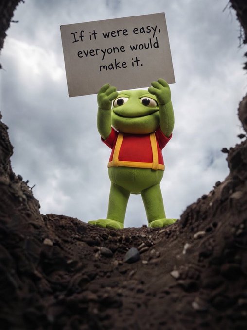A cheerful green frog plush toy stands in a dirt hole holding a handwritten sign that reads "If it were easy, everyone would make it," humorously tying into the "$TOAD and chill" post by suggesting crypto gains come only to the dedicated few.