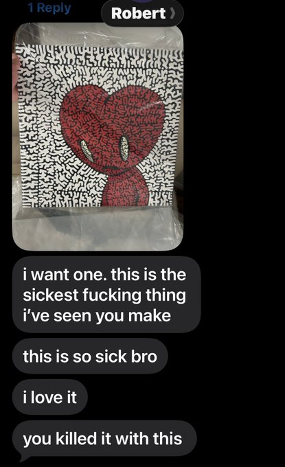 A text message conversation where 'Robert' sends a picture of a red Spider-Man drawing in a plastic sleeve, and the recipient enthusiastically replies, 'i want one. this is the sickest fucking thing i've seen you make' and 'you killed it with this'.