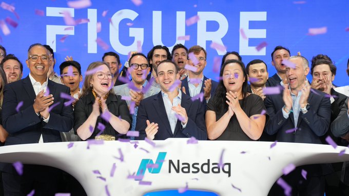 A group of people in business attire cheer and clap while standing behind a Nasdaq podium during a 'FIGURE' event, with purple confetti raining down around them.