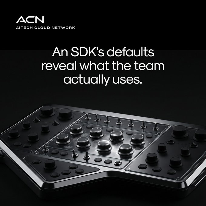 A sleek black control device covered in various knobs, buttons, and switches sits beneath the ACN (AI Tech Cloud Network) logo and the text "An SDK's defaults reveal what the team actually uses." The image visually reinforces the post's message by showing a controller's preset configuration—paralleling how an SDK's default settings expose the practical choices and priorities of the developers behind it, much like the arranged controls reflect the intended use of the device.