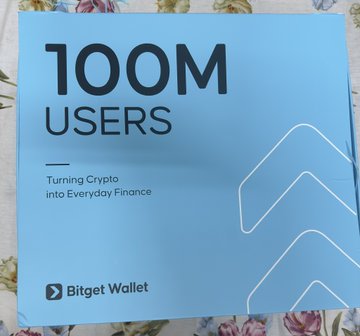 A blue Bitget Wallet promotional box celebrating 100 million users and the platform's 8th anniversary, featuring the tagline "Turning Crypto into Everyday Finance" and an arrow graphic alongside the Bitget Wallet logo.