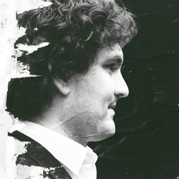 A black and white stylized portrait photograph showing a man with curly hair in profile view against a textured dark background.