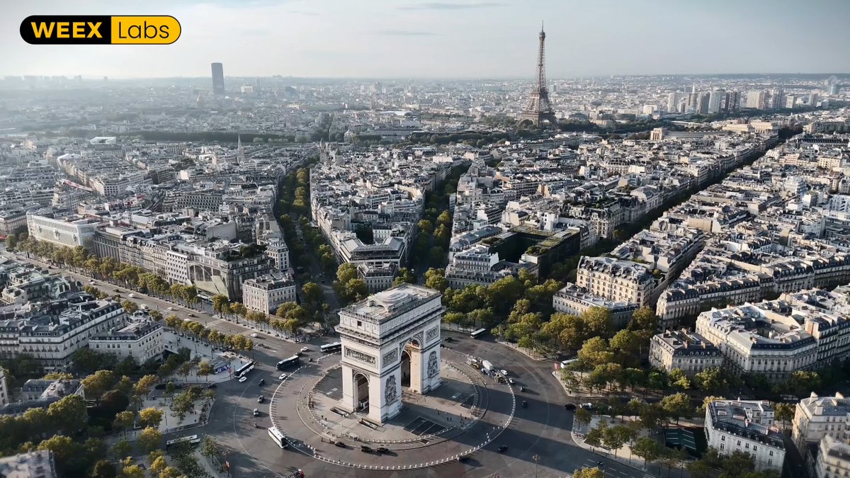 The image features an aerial view of Paris, France with the Arc de Triomphe prominently displayed at the center. The cityscape includes numerous buildings and roads, showcasing the bustling urban environment. A yellow banner reading "WEEX" can be seen in the top left corner of the photo.