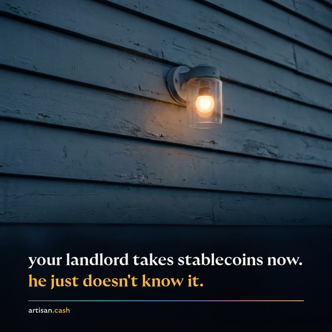 A wall-mounted outdoor light fixture on blue wooden siding with text reading 'your landlord takes stablecoins now. he just doesn't know it.' and 'artisan.cash'.