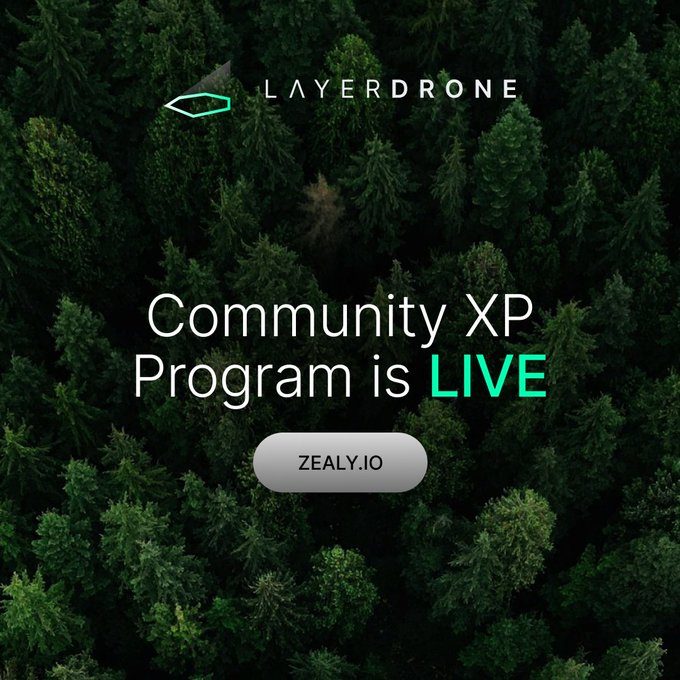 The image features a forest with green trees and a white button that says "Zealy". The text above the button reads "Community XP Program is Live", indicating that the XP rewards system is currently active, and users can access them by connecting their wallets to their Zealy account.