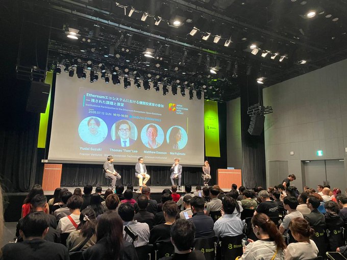 A panel discussion at the Polygon Connects Tokyo event titled "Ethereumエコシステムにおける補助政策の参加" featuring speakers Yudai Suzuki, Thomas "Tom" Lee, Matthew Dawson, and Mai Fujimoto, with a seated audience in the foreground.