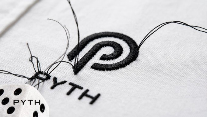 A close-up of a white embroidered fabric featuring the Pyth Network logo—a stylized black spiral resembling a snail shell—and the text "PYTH" stitched below it, with loose black threads trailing from the in-progress embroidery. The image ties into the post by teasing Pyth Network's new branding, which the author had predicted weeks before its official reveal.