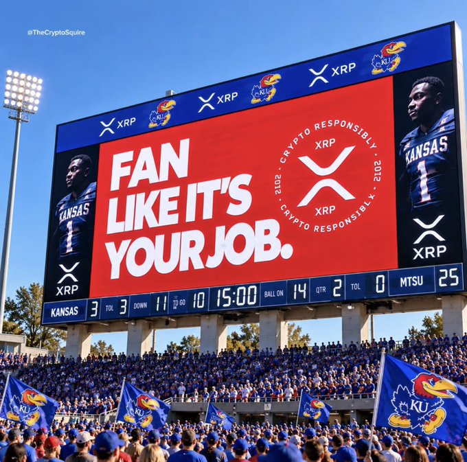A stadium scoreboard showing a Kansas Jayhawks football game against MTSU with a score of 14-25, featuring a large red advertisement for XRP that reads 'FAN LIKE IT'S YOUR JOB.'