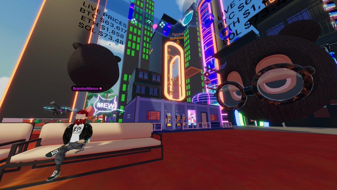Screenshot from a VR/metaverse platform showing an avatar sitting on a white sofa in a cyberpunk city environment with a large floating cat character.