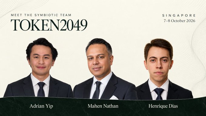A promotional banner for "TOKEN2049" in Singapore (7-8 October 2026) introducing "The Symbiotic Team" with names Adrian Yip, Mahen Nathan, and Henrique Dias below their portraits.