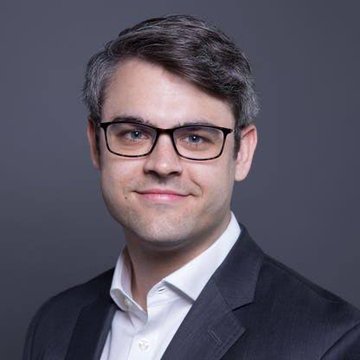 A professional headshot of a man with glasses wearing a dark blazer and white shirt, likely a financial analyst or industry expert, accompanies news that Bitwise ETF clients purchased $19.16 million worth of $XRP.
