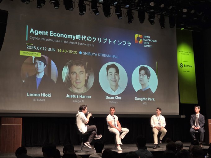 A panel discussion at the Japan Blockchain Week Summit titled 'Agent Economy' on 2026.07.12, moderated by Leona Hioki (INTMAX), with panelists Justus Hanna (Grego AI), Sean Kim (Virtuals), and SungMo Park (4V2).