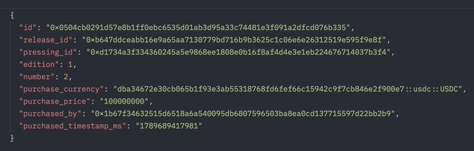 A code snippet displayed on a dark background showing a JSON object with fields including id, release_id, pressing_nid, purchase_currency (dba34672e30cb065b1f93e3ab55318768fd6fef66c1594cf9f7cb846e2f906e7::usdc::USDC), purchase_price (100000000), and purchase_timestamp_ms (1789689417981).