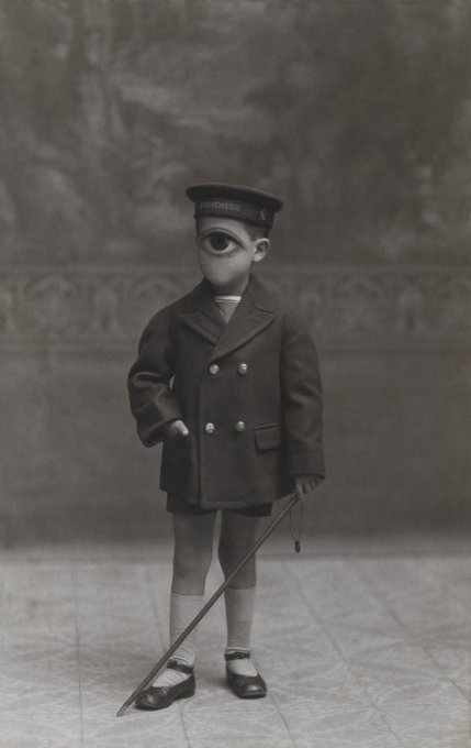 In a surreal twist, a young boy is depicted wearing a captain's hat with an eye on the brim in this grayscale image. The accompanying text "XCLPD: Persephone .33eth on SR" might suggest a play on names and themes, evoking the mythological character Persephone, thereby connecting the whimsical nature of the image with a story from Greek mythology, potentially hinting at an underlying narrative or commentary within the artwork.