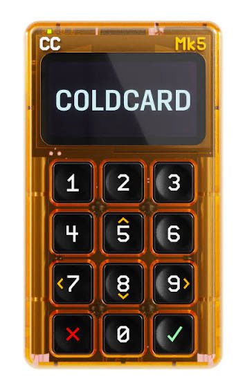 The image shows a COLDCARD Mk5, a translucent orange Bitcoin hardware wallet featuring a numeric keypad and a small display screen showing the "COLDCARD" brand name. The device represents the very security tool that issued the emergency advisory, as COLDCARD has warned users about potentially compromised seed phrase generation in certain wallets.