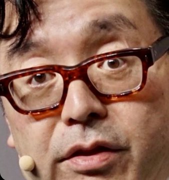 In the image, there's a man wearing glasses who appears to be speaking or making a face, possibly expressing surprise or frustration. The context of this scene is related to an event that took place in 2012 when the man converted Bitcoin into Ethereum, losing $8.7B in value as a result of his decision. This event highlights how rapidly digital currency like Bitcoin can change its worth, and it serves as a cautionary tale about investing or exchanging money without thorough research or guidance from financial professionals.
