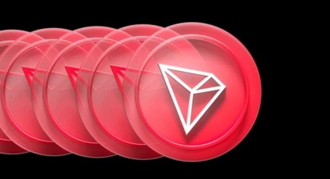 A row of glossy red coins, each displaying the white Tron (TRX) triangular logo, recedes into the distance against a black background.