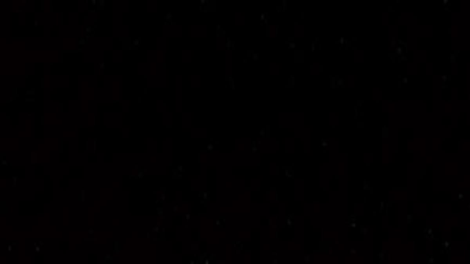 A nearly black image with very faint scattered dots, appearing to be an underexposed or blank photograph.