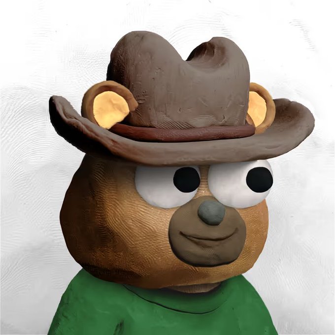 A 3D sculpted character resembling a monkey or bear wearing a brown cowboy hat and green shirt, with large googly eyes, presented against a white background.