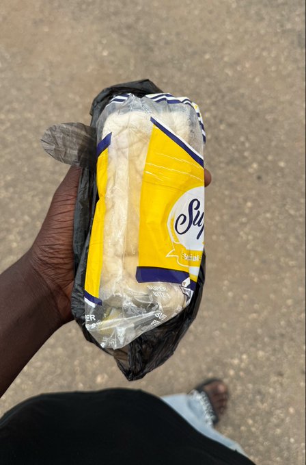 A hand holds a plastic-wrapped pack of "Supreme" sliced bread inside a black plastic bag, standing on a paved street. The image illustrates the post's complaint about being sent on a menial errand to buy bread and beans, despite having 12.6k followers and trading experience on 0xwale.