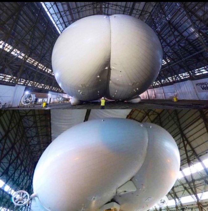Two views of a massive, bulbous white hybrid airship inside a large industrial hangar with a worker in a yellow vest standing beneath it for scale.