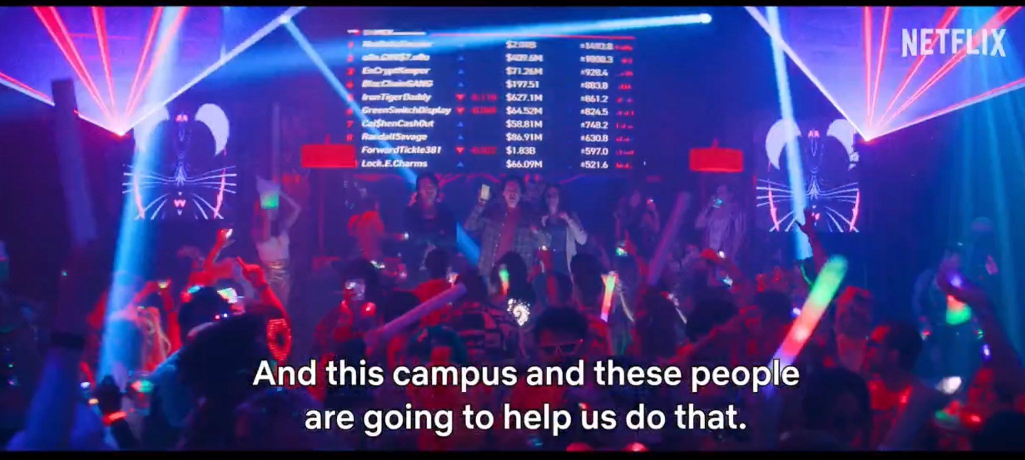 A crowd at a Netflix party dances under red and blue laser lights beneath a leaderboard displaying crypto usernames (like "IronTigerDaddy" and "GetShenCashOut") and dollar amounts such as $2.3B and $1.83B, with the subtitle "And this campus and these people are going to help us do that." The image illustrates the lavish, Las Vegas-style "Lifestyle Villa" event that SBF hosted for influencers, contrasting the Netflix dramatization with what actually occurred.