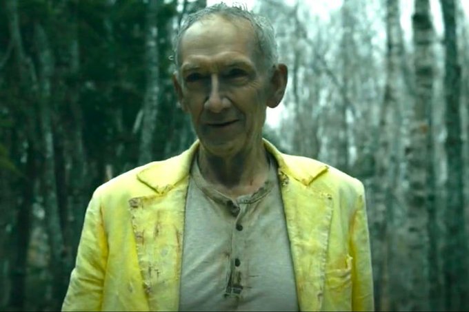 The image features an older man wearing a yellow jacket, standing in front of trees with green foliage. The man appears to be smiling at the camera, possibly posing for a photo or video. In the background, there are some trees that add depth to the scene and create a sense of being outdoors. The post about Bitcoin and Eth seems unrelated to the main subject of the image, which is the older man in the yellow jacket.