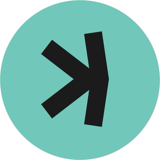 A circular logo featuring a stylized black arrow or play-button-like symbol on a teal background.