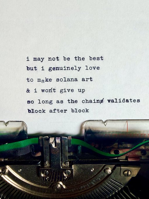 A photograph of a typewriter printing a heartfelt message that reads 'i may not be the best but i genuinely love to make solana art & i won't give up so long as the chains validates block after block'.