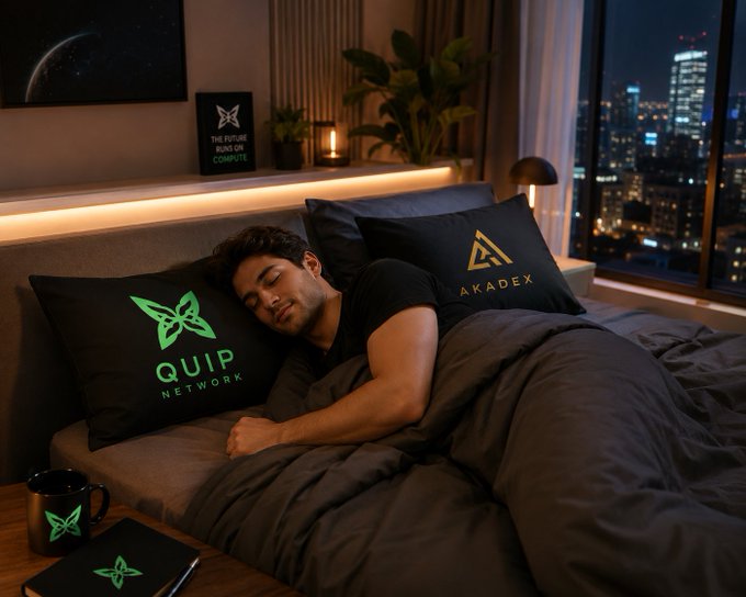 A man sleeps peacefully in a modern bedroom with a city skyline view, surrounded by Akadex and Quip Network branded pillows, a mug, and a laptop.
