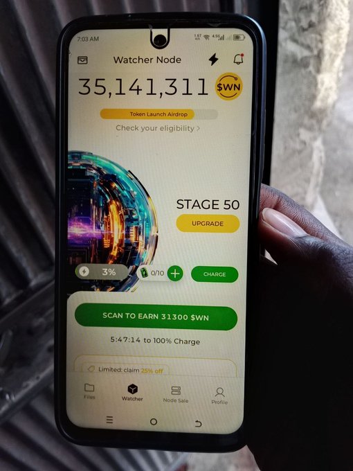 A hand holds a smartphone displaying the "Watcher Node" app showing a balance of 35,141,311 $WN tokens at Stage 50, highlighting the "Token Launch Airdrop" eligibility check and a "SCAN TO EARN 31300 $WN" prompt that ties directly to the live node launch securing the DeNet storage network from Ohio.