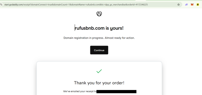 GoDaddy domain registration confirmation page showing "rufusbnb.com is yours!" with a message that domain registration is in progress and a "Continue" button, along with a thank you order confirmation below.