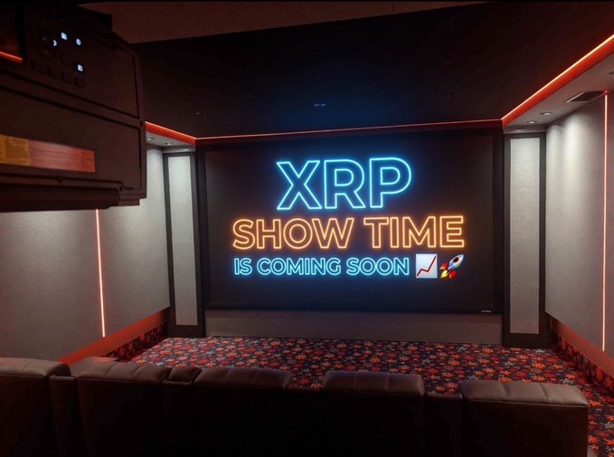 Neon-lit home theater room with a sign on the screen reading 'XRP SHOW TIME IS COMING SOON 🚀📈'.