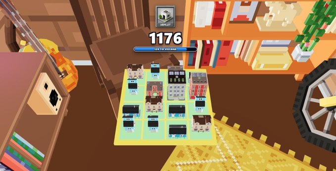 A voxel-style "TinyRoom City" mini-game scene displays a miniature grid-based city with the number "1176" and a progress bar showing "176 TO VILLAGE" at the top, set against a room backdrop with bookshelves, a guitar, and a wheel. The image illustrates the gameplay described in the post, where players place and combine blocky buildings to grow their virtual city.