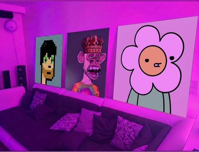 A living room illuminated by purple lighting, featuring three large artworks on the wall: a pixelated green character, a screaming crowned figure, and a cartoon flower.